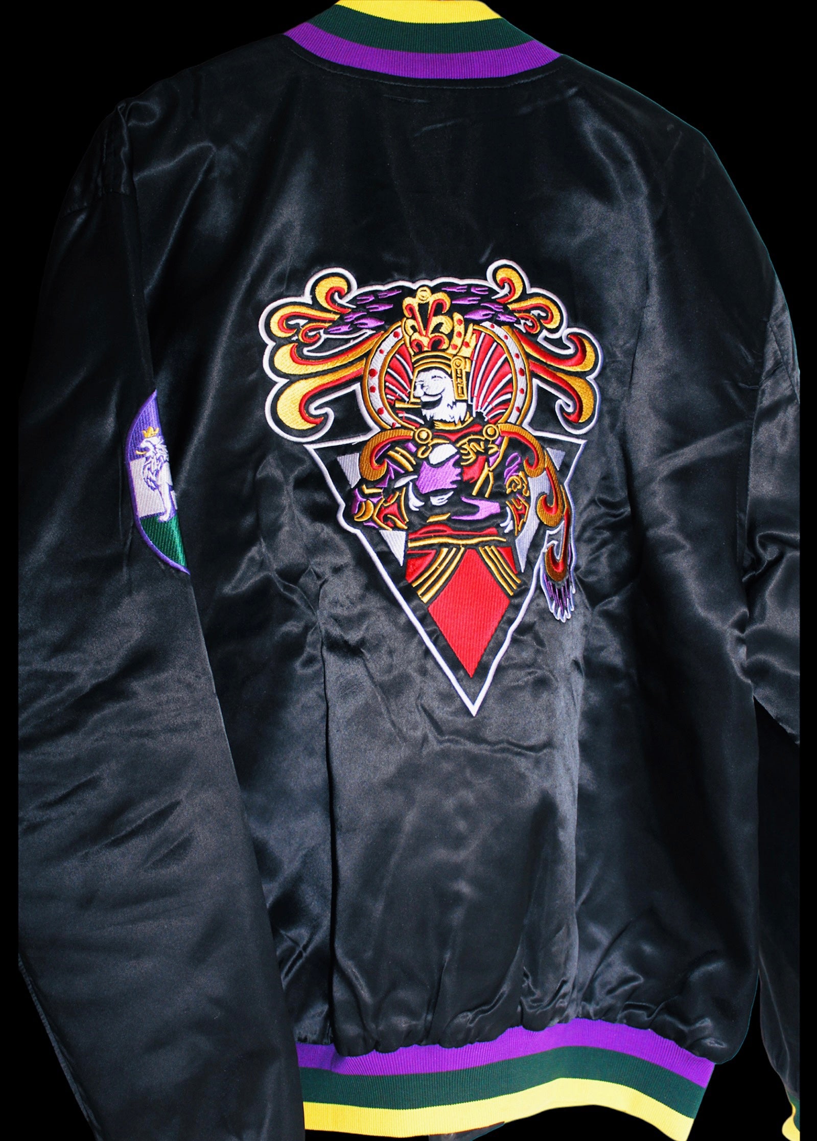 Close-up of the embroidered logo on the Royalty10 Zulu Mardi Gras 23 Satin Bomber Jacket, showcasing intricate details and vibrant colors.